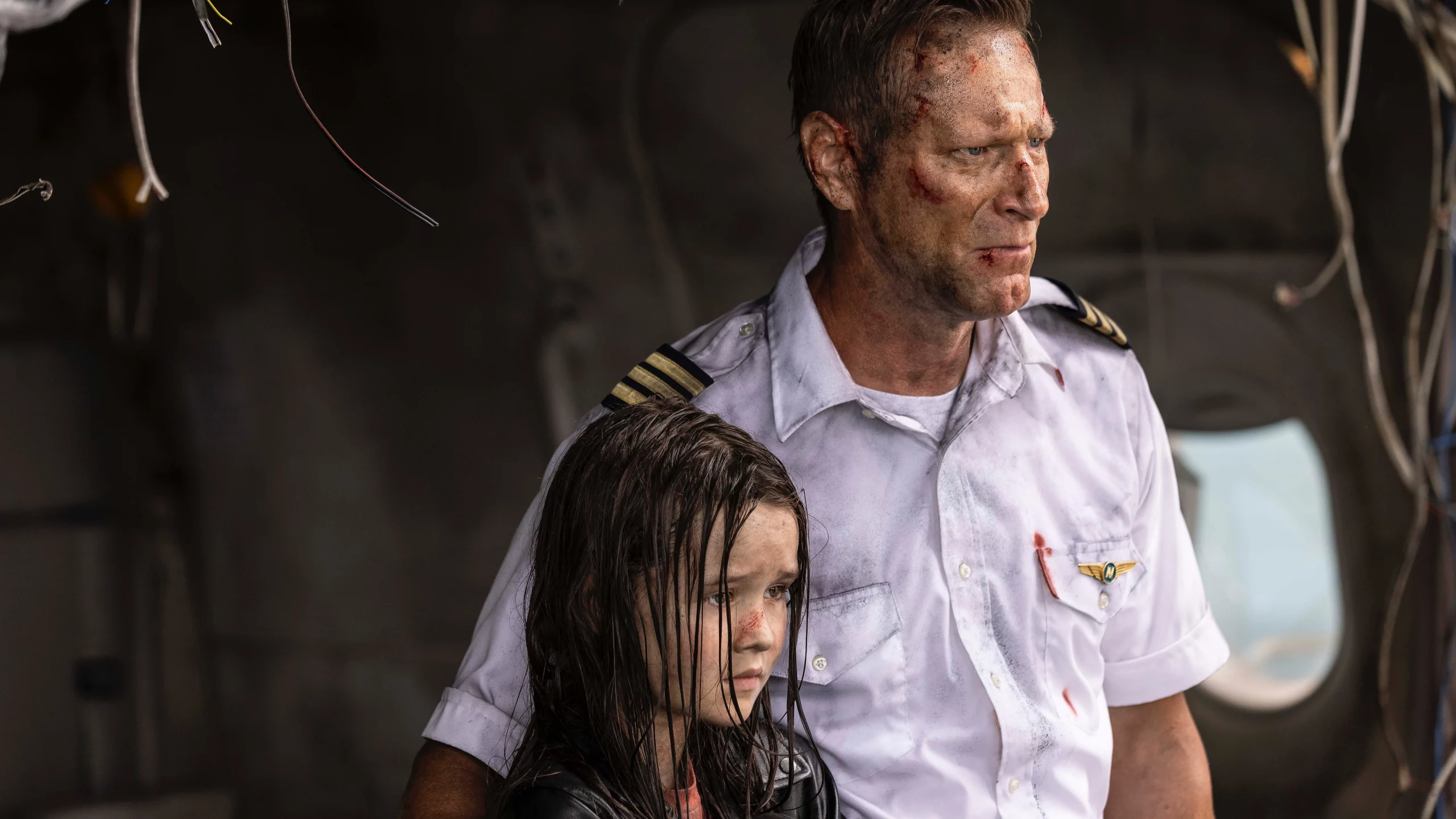 A pilot and a girl in the wreckage of an airplane.